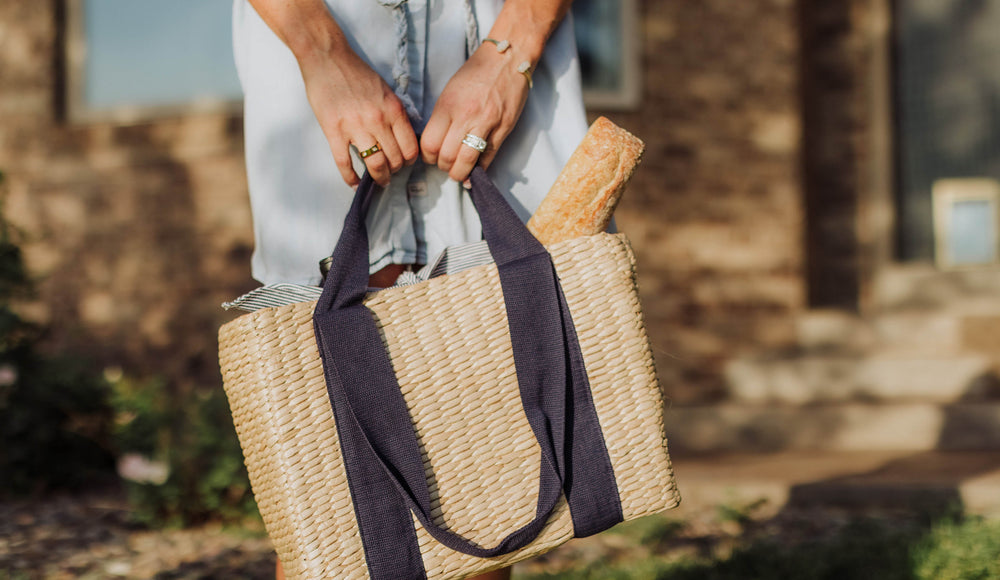 woman carrying picnic tote