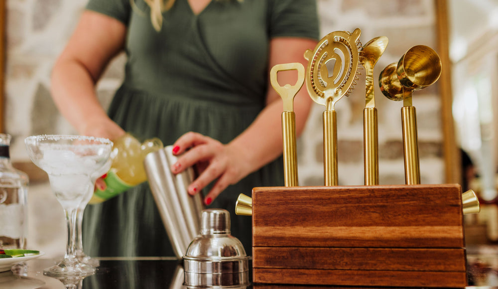 woman making a margarita using a tabletop bar set