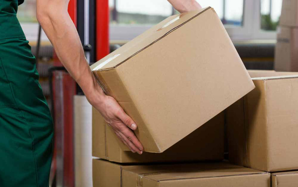 Box being stacked on a pallet of boxes
